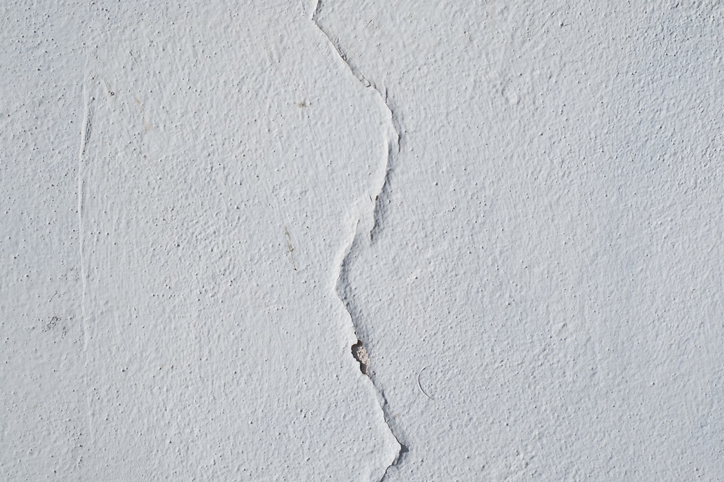 Inside Out Painting team Inspecting Cracked white paint texture house exterior in New Jersey